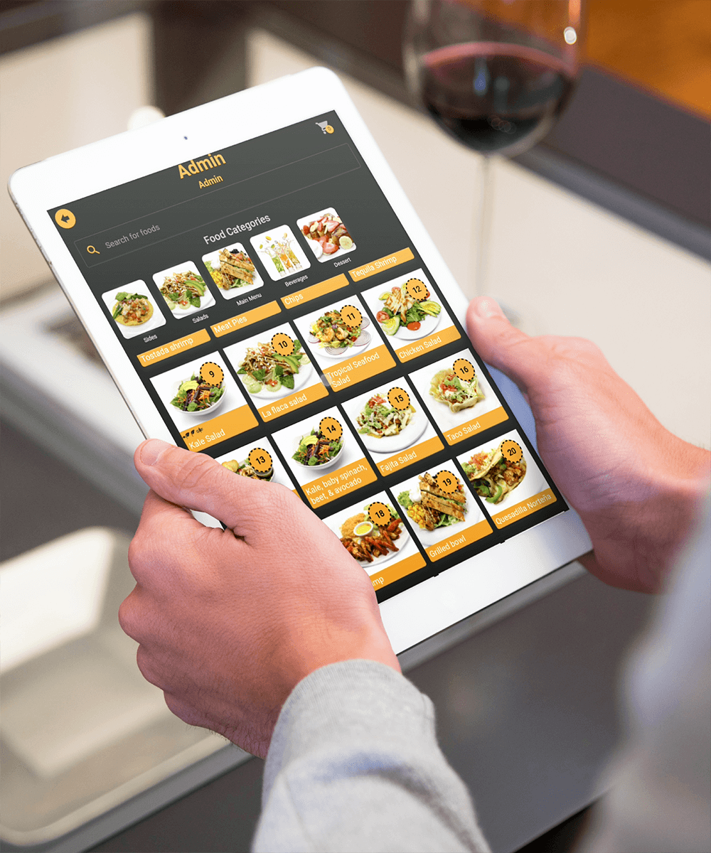 Restaurant manager using an ordering app on a tablet